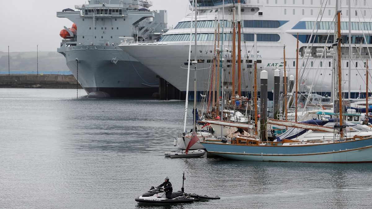 A border force officer rides on a jet ski in Falmouth harbour with a RFA (Royal Fleet Auxiliary) Argus ship in the background, as preparations are underway for the G7 leaders summit, Cornwall, Britain. Credit: Reuters Photo