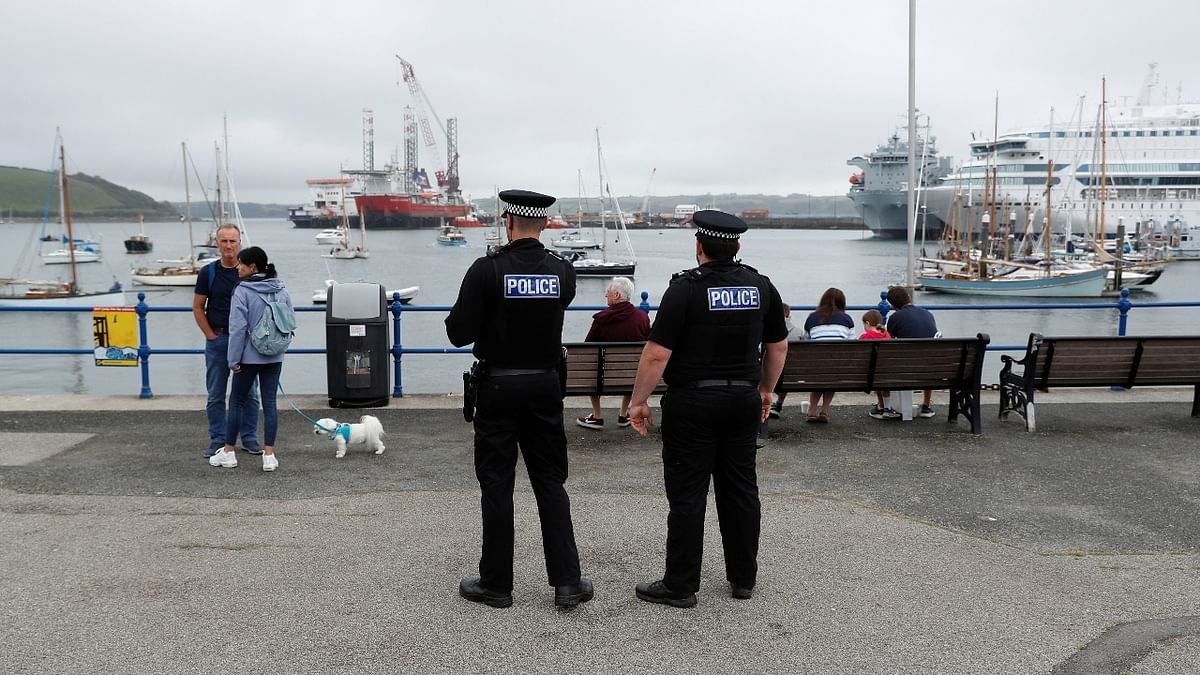 Police officers look out onto Falmouth harbour, as preparations are underway for the G7 leaders summit, Cornwall, Britain. Credit: Reuters Photo