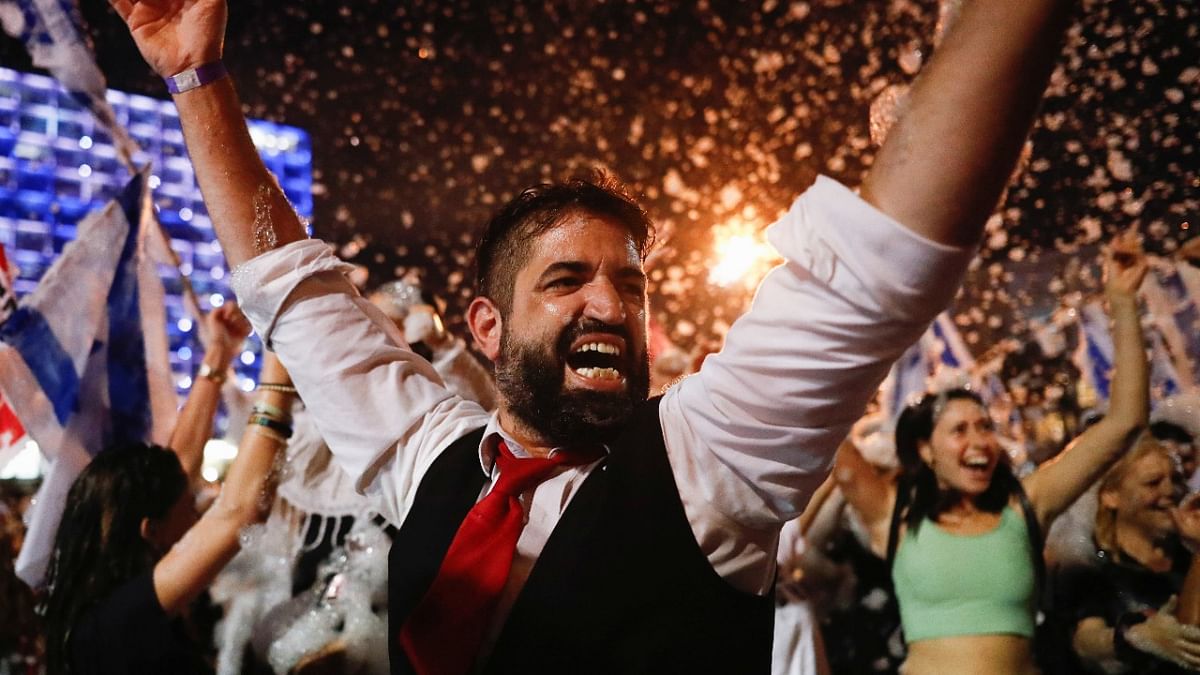People celebrate after Israel's parliament voted in a new coalition government, ending Benjamin Netanyahu's 12-year hold on power, at Rabin Square in Tel Aviv, Israel. Credit: Reuters Photo