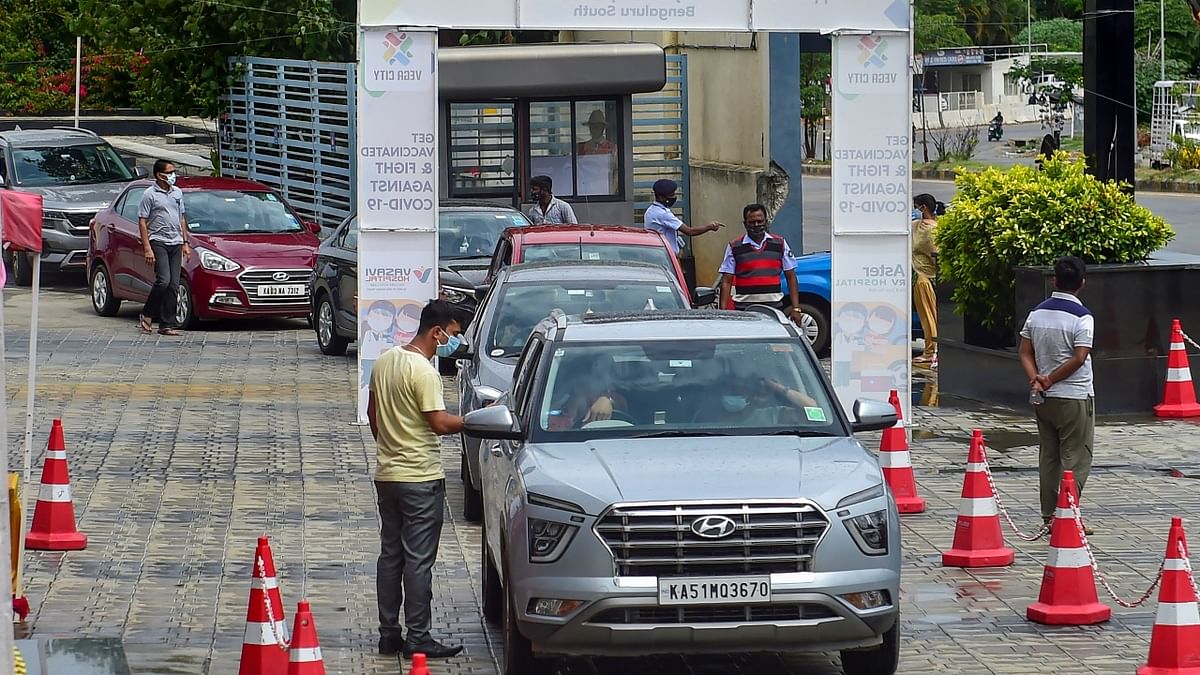 People wait in their vehicles at a drive-in vaccination centre, in Bengaluru. Credit: PTI Photo