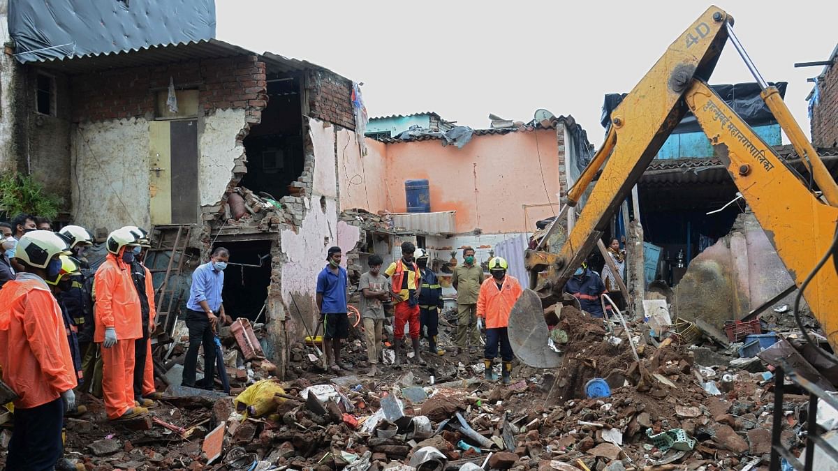 Civic authorities and rescue personnel search for survivors in the debris of a building that collapsed following heavy monsoon rains, in Mumbai.