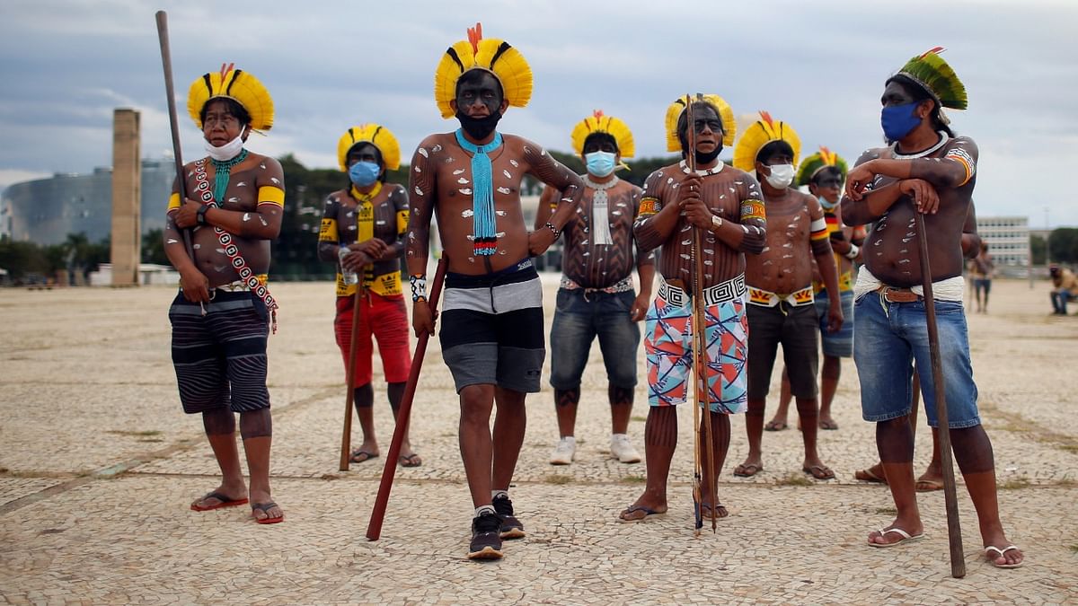 Indigenous Brazilians from different ethnic groups take part in a protest for land demarcation and against President Jair Bolsonaro's government, in front of the Planalto Palace in Brasilia, Brazil. Credit: Reuters Photo