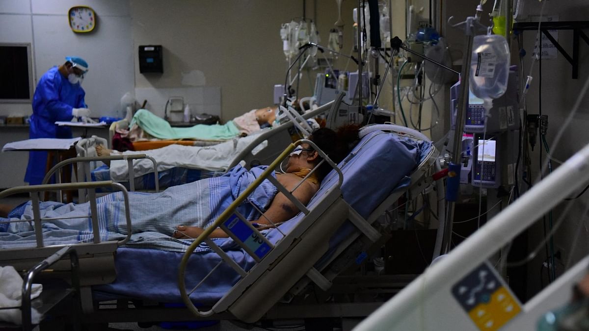 Covid-19 patients are assisted by health workers at the Intensive Care Unit in the Hospital de Clinicas, in San Lorenzo, Paraguay. Credit: AFP Photo