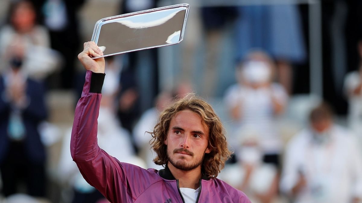 Greece's Stefanos Tsitsipas poses with the runners up trophy after losing the final against Serbia's Novak Djokovic. Credit: Reuters Photo