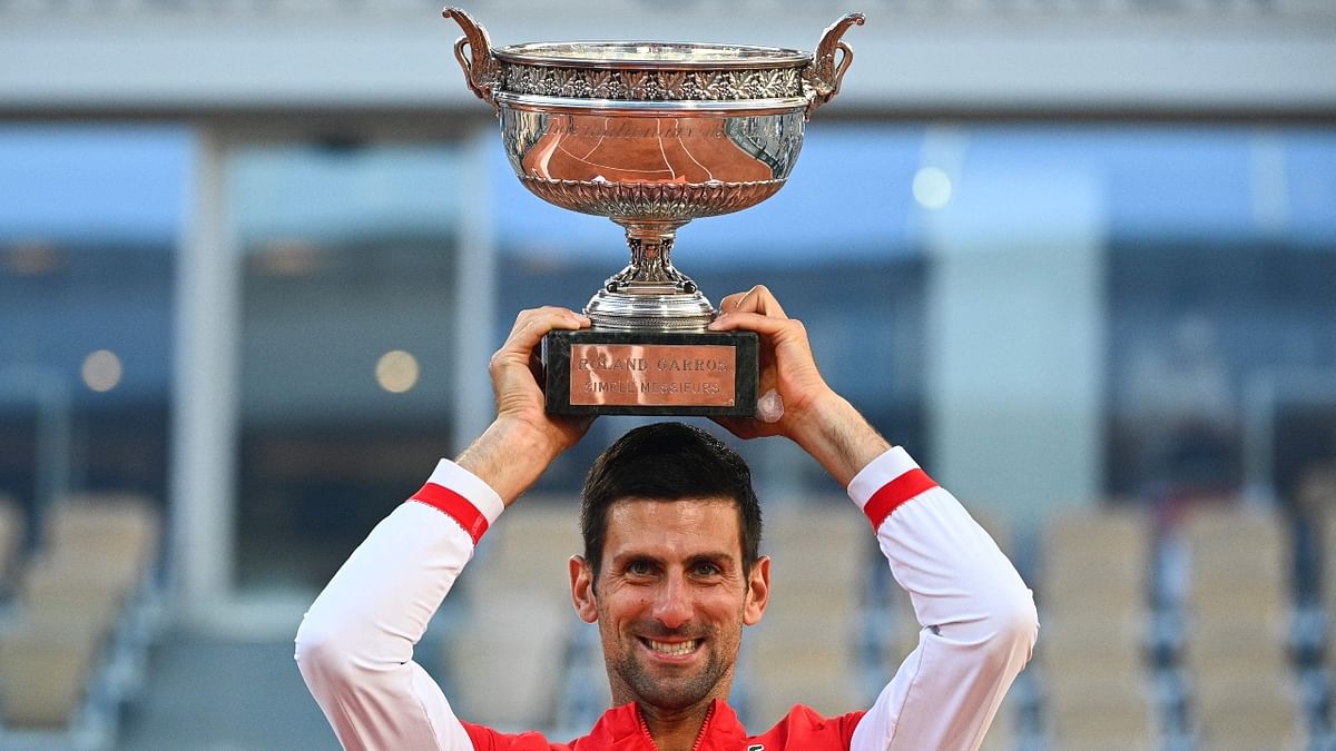 Serbia's Novak Djokovic poses with The Mousquetaires Cup (The Musketeers) after winning against Greece's Stefanos Tsitsipas at the end of their men's final tennis match on Day 15 of The Roland Garros 2021 French Open tennis tournament in Paris. Credit: AFP Photo