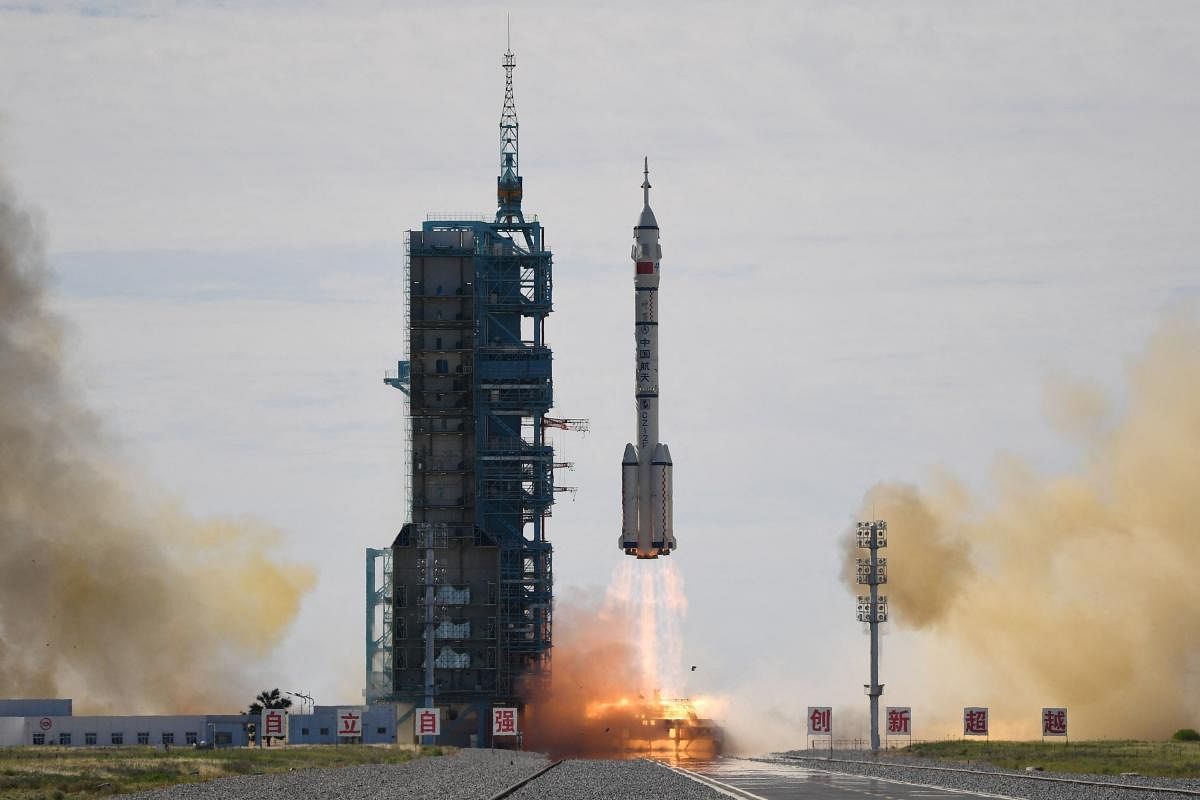 A Long March-2F carrier rocket, carrying the Shenzhou-12 spacecraft and a crew of three astronauts, lifts off from the Jiuquan Satellite Launch Centre in the Gobi desert, in northwest China on June 17, 2021, the first crewed mission to China's new space station. Credit: AFP Photo