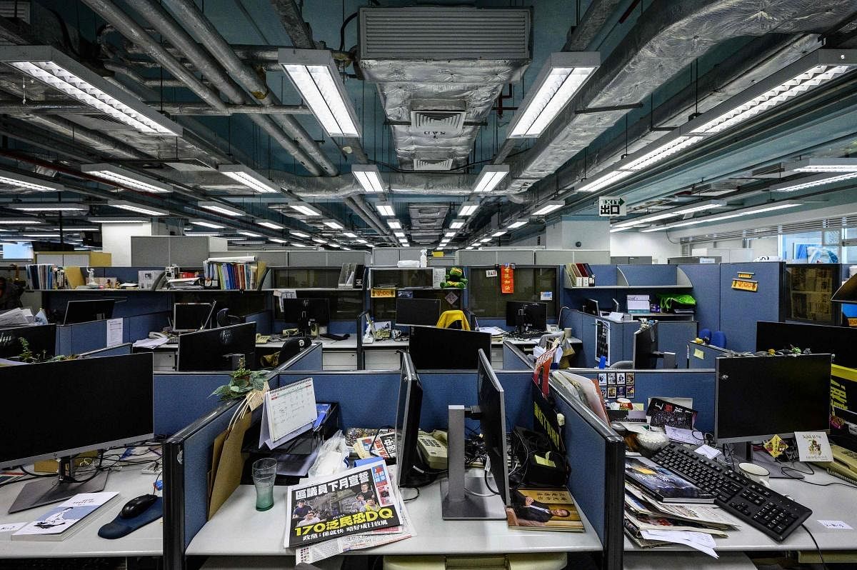 Monitors are seen detached from desktop computers at the Apple Daily political desk, after they were taken away as evidence from the local paper's newsroom in Hong Kong police arrested the chief editor and four executives of the pro-democracy newspaper. Credit: AFP Photo