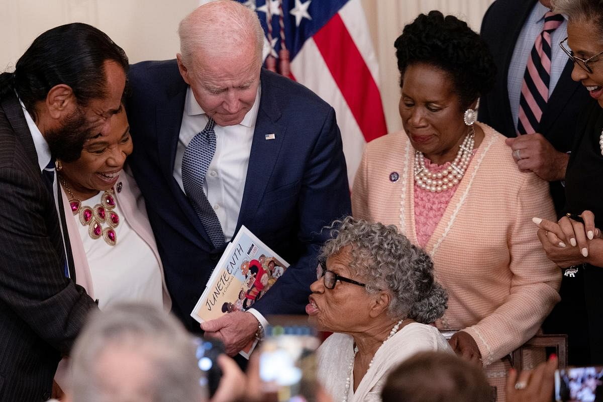 US President Joe Biden listens to Opal Lee, a 94-year-old activist and retired educator in Fort Worth, Texas, after Biden signed the Juneteenth National Independence Day Act into law during a ceremony in the East Room of the White House in Washington, US. Credit: Reuters Photo
