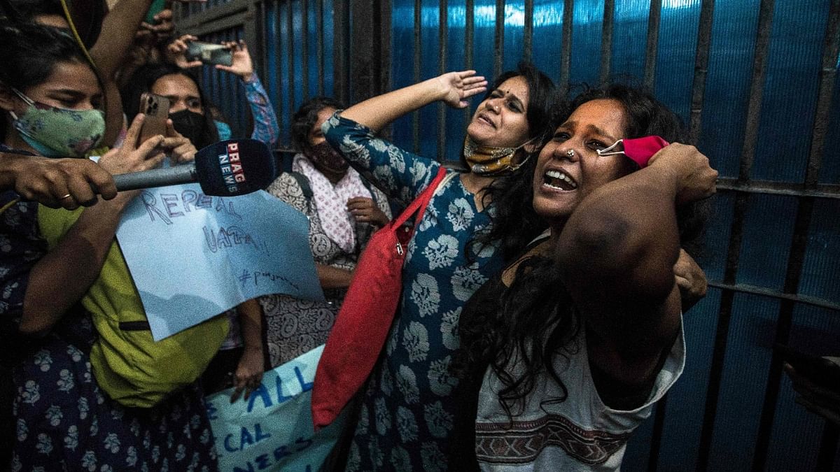 Devangana Kalita and Natasha Narwal shout slogans after being released from Tihar jail in New Delhi. Credit: AFP Photo