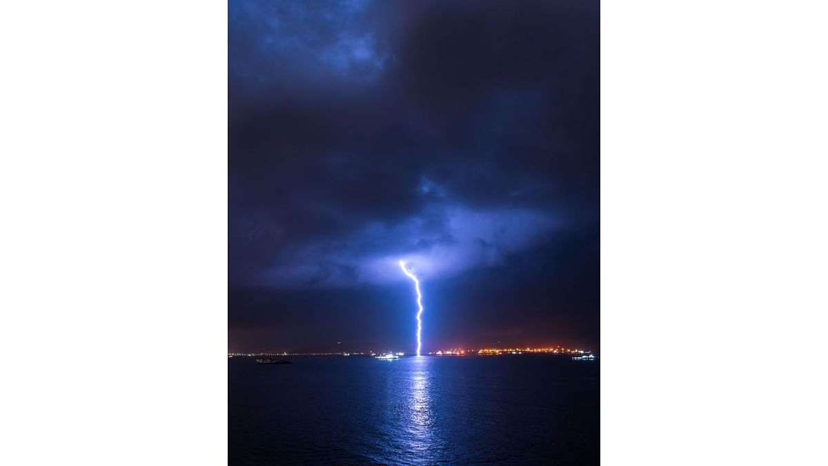 Heavy lightning illuminates the sky during a thunderstorm.