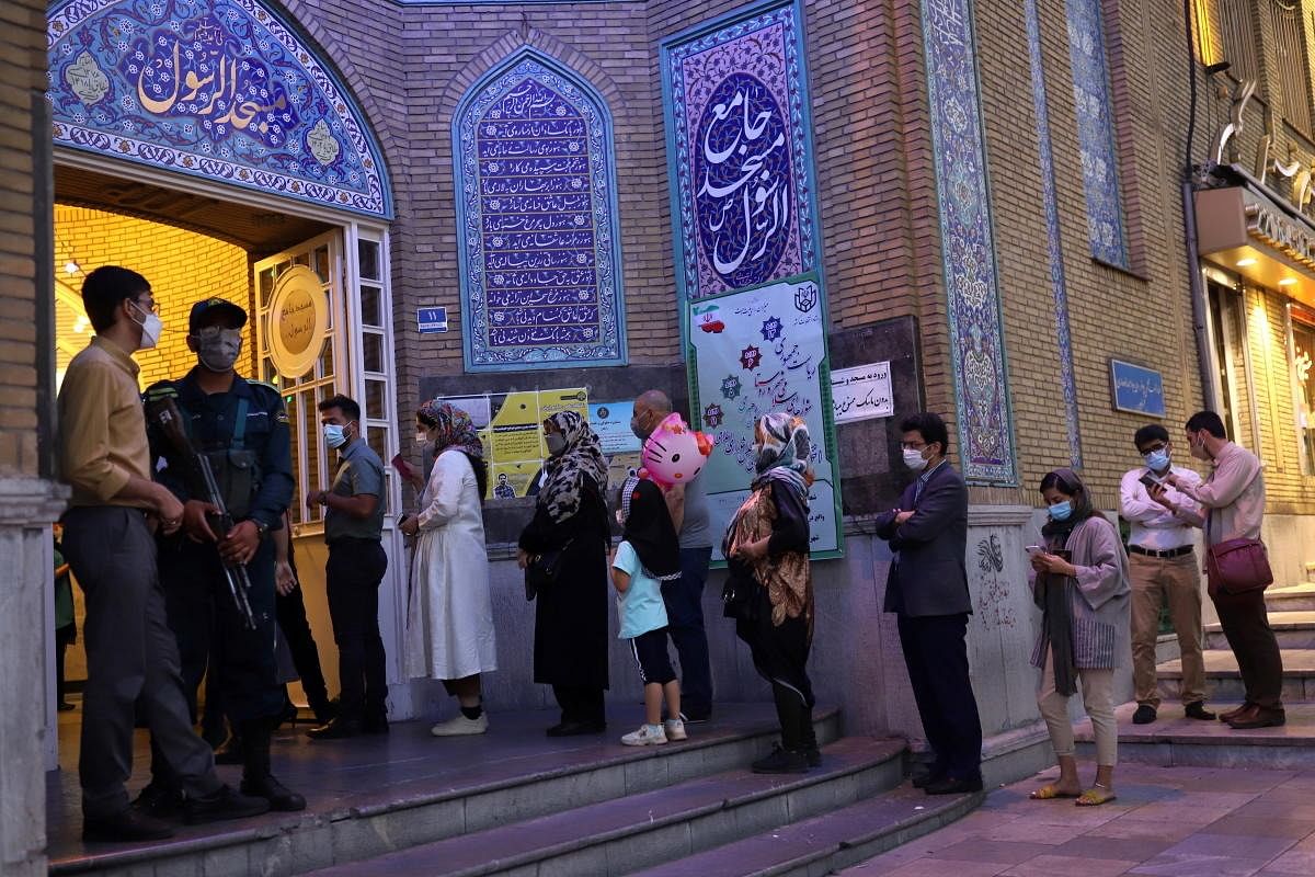 Voters wait in line at a polling station during the presidential election in Tehran, Iran. Credit: Reuters Photo