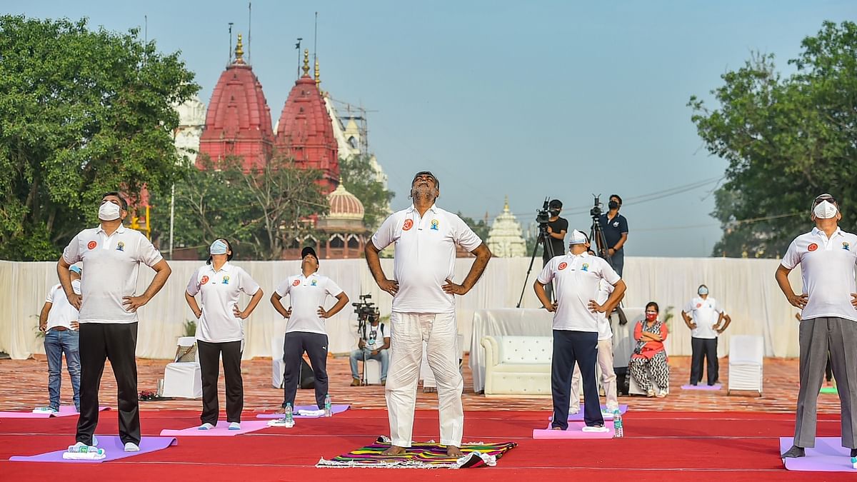Culture and Tourism Minister Prahlad Singh Patel perform Yoga with others on International Day of Yoga at Red Fort in New Delhi. Credit: PTI Photo