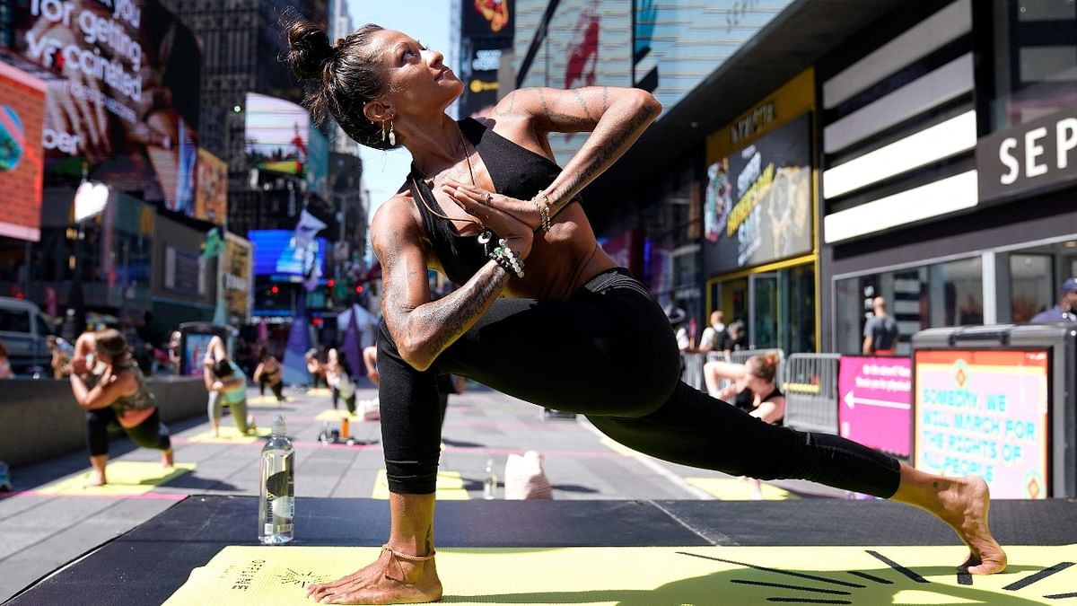 A participant performs asanas during “Solstice in Times Square: Mind Over Madness Yoga,” an annual all-day outdoor yoga event in the heart of Times Square in New York. Credit: AFP Photo