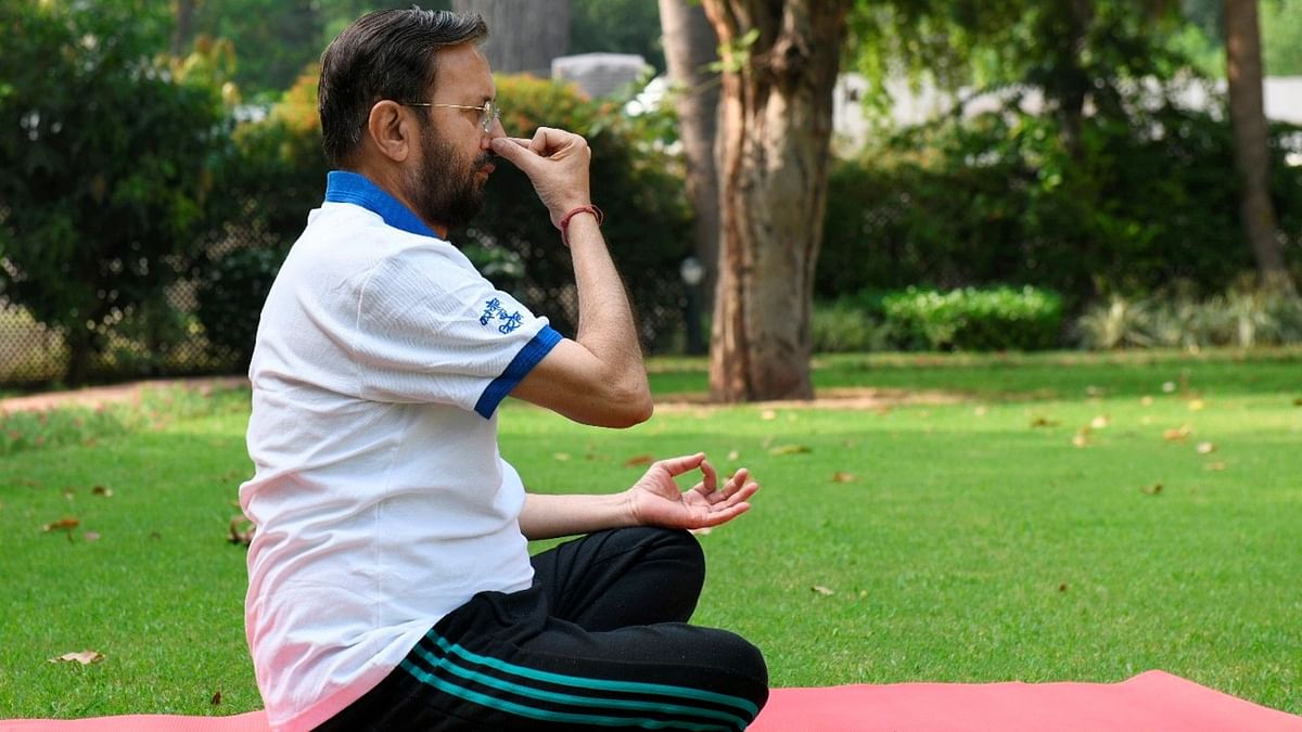 Union Minister for Environment, Forest & Climate Change, Information & Broadcasting and Heavy Industries and Public Enterprise, Prakash Javadekar is seen practising Pranayama on the occasion of the 7th International Day of Yoga 2021, in New Delhi. Credit: PTI Photo