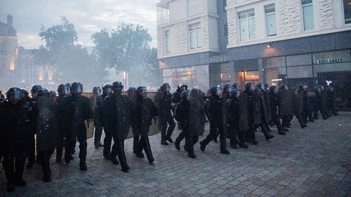 Anti-riot gendarmes stand in faction during a second protest to mark the second anniversary of the death of Steve Maia Canico, a Frenchman who died after falling in the river following a police raid during France's annual nationwide Fete de la Musique celebrations in 2019, in the city of Nantes. Credit: AFP Photo
