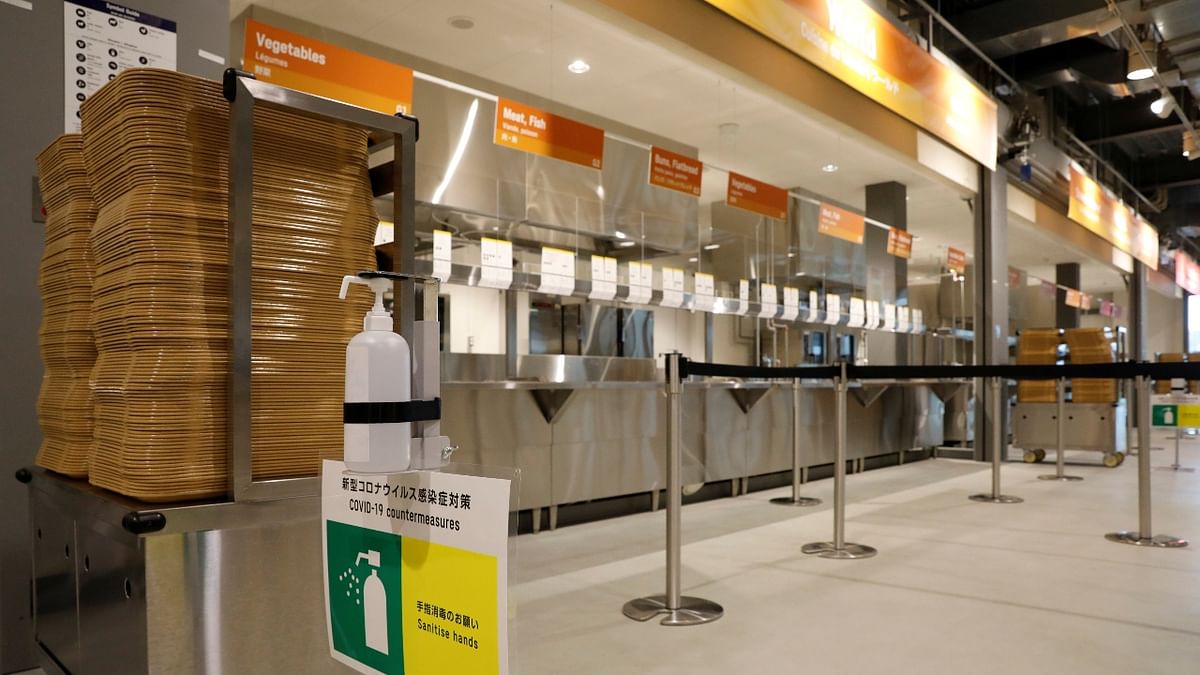 A hand sanitizer and a sign for Covid counter-measures are placed at the main dining hall of Tokyo 2020 Olympic and Paralympic Village, in Tokyo, Japan.