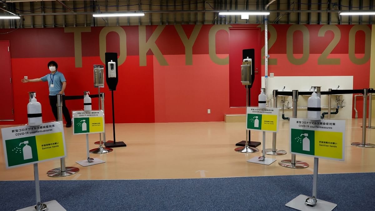 Hand sanitizers and signs for Covid-19 counter-measures are placed at the entrance of the fitness center at the multi-function complex of Tokyo 2020 Olympic and Paralympic Village in Tokyo, Japan.
