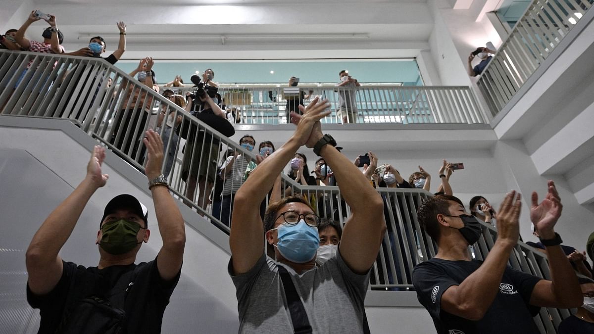 Apple Daily employees cheer each other on their last day of their work. Credit: AFP Photo