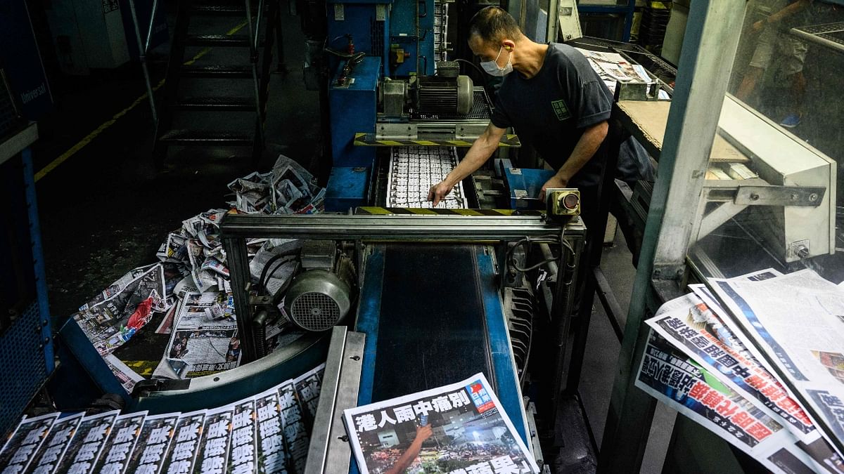 A worker is seen in the printing room as the last edition of the newspaper is printed in Hong Kong. Credit: AFP Photo