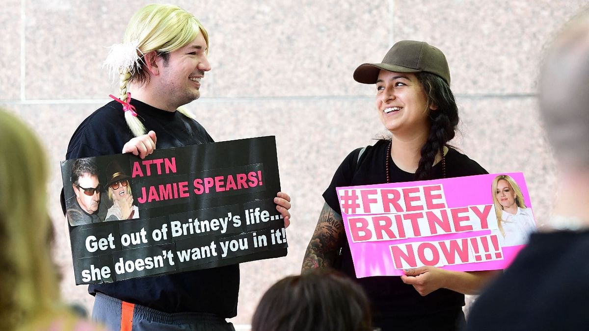 Fans and supporters of Britney Spears hold placards as they gather outside the County Courthouse in Los Angeles, California on June 23, 2021, during a scheduled hearing in Britney Spears' conservatorship case. Credit: AFP Photo