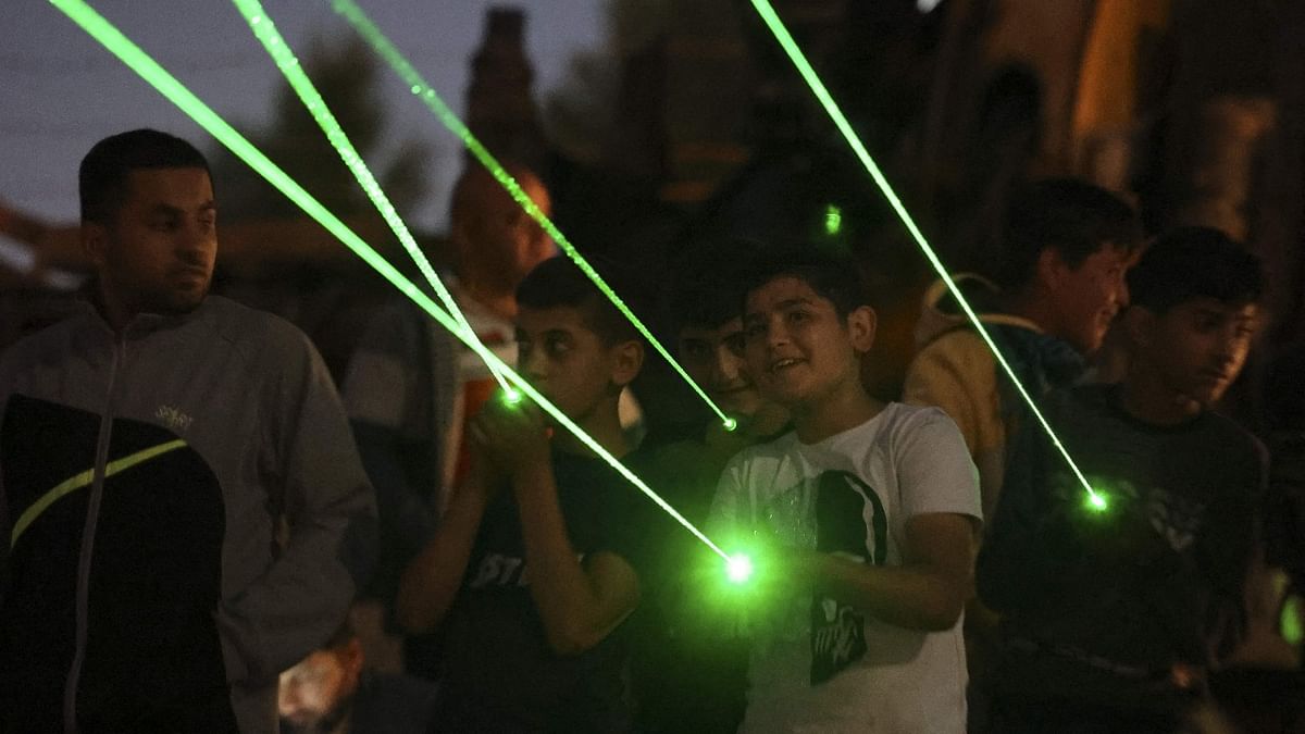 Young Palestinians shine laser torches during a night demonstration against the expansion of a Jewish settlement on the lands of Beita village, near the occupied West Bank city of Nablus. Credit: AFP Photo