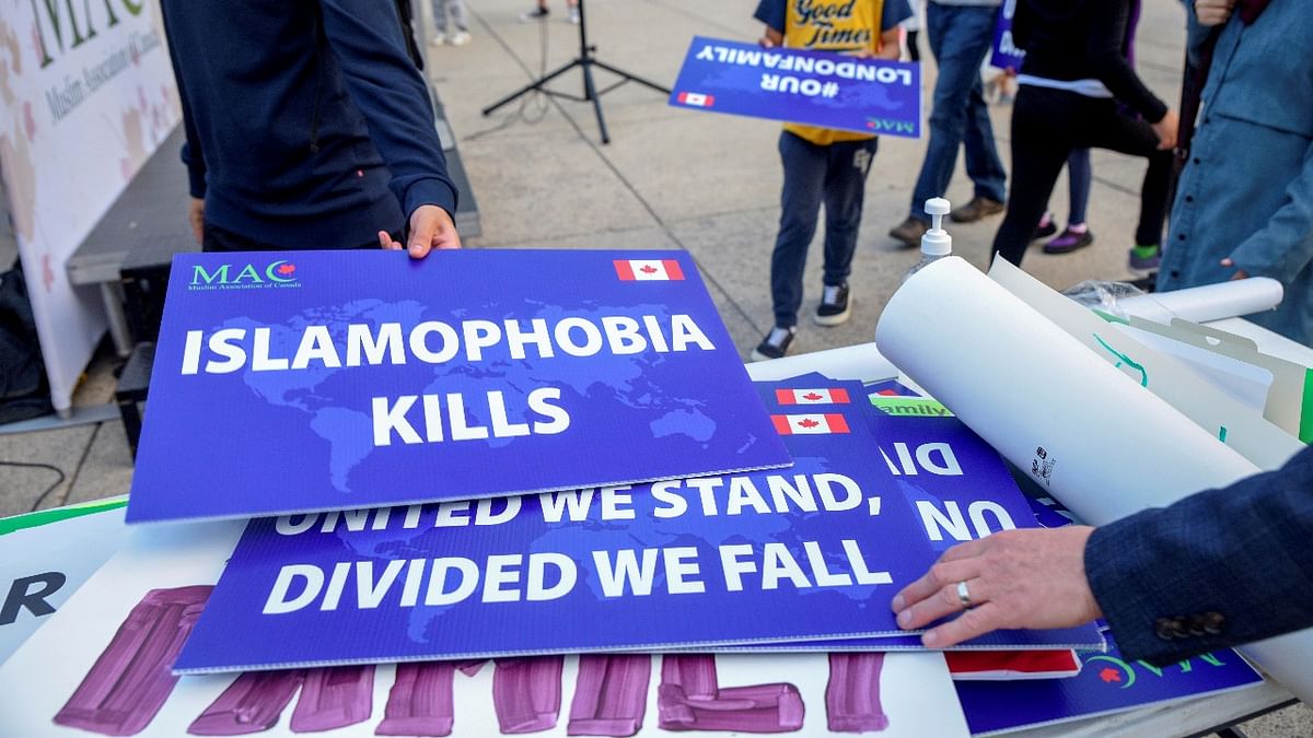 Attendees return signs after a rally to highlight Islamophobia, sponsored by the Muslim Association of Canada, including the June 6 in London, Ontario attack which killed a Muslim family in what police describe as a hate-motivated crime. Credit: Reuters photo