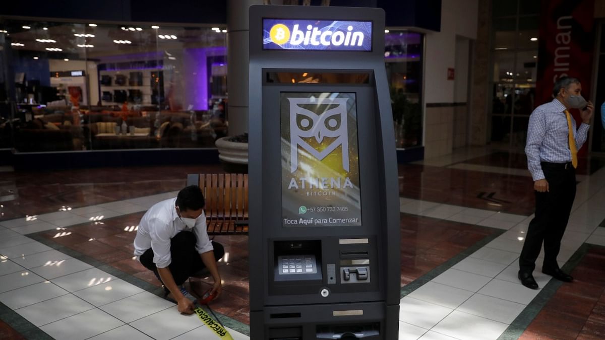 A worker installs a Bitcoin ATM for a presentation in San Salvador. Credit: Reuters photo