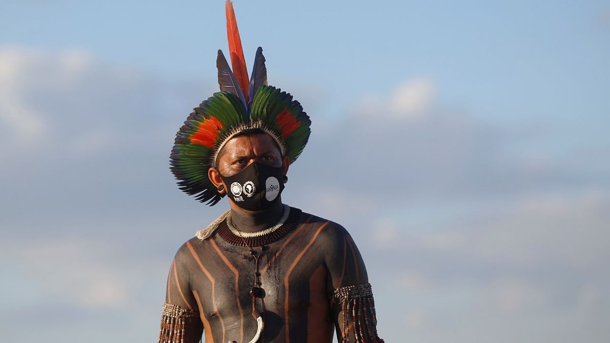 An Indigenous Brazilians looks on during a protest for land demarcation, outside Brazil's Supreme Federal Court in Brasilia. Credit: Reuters photo