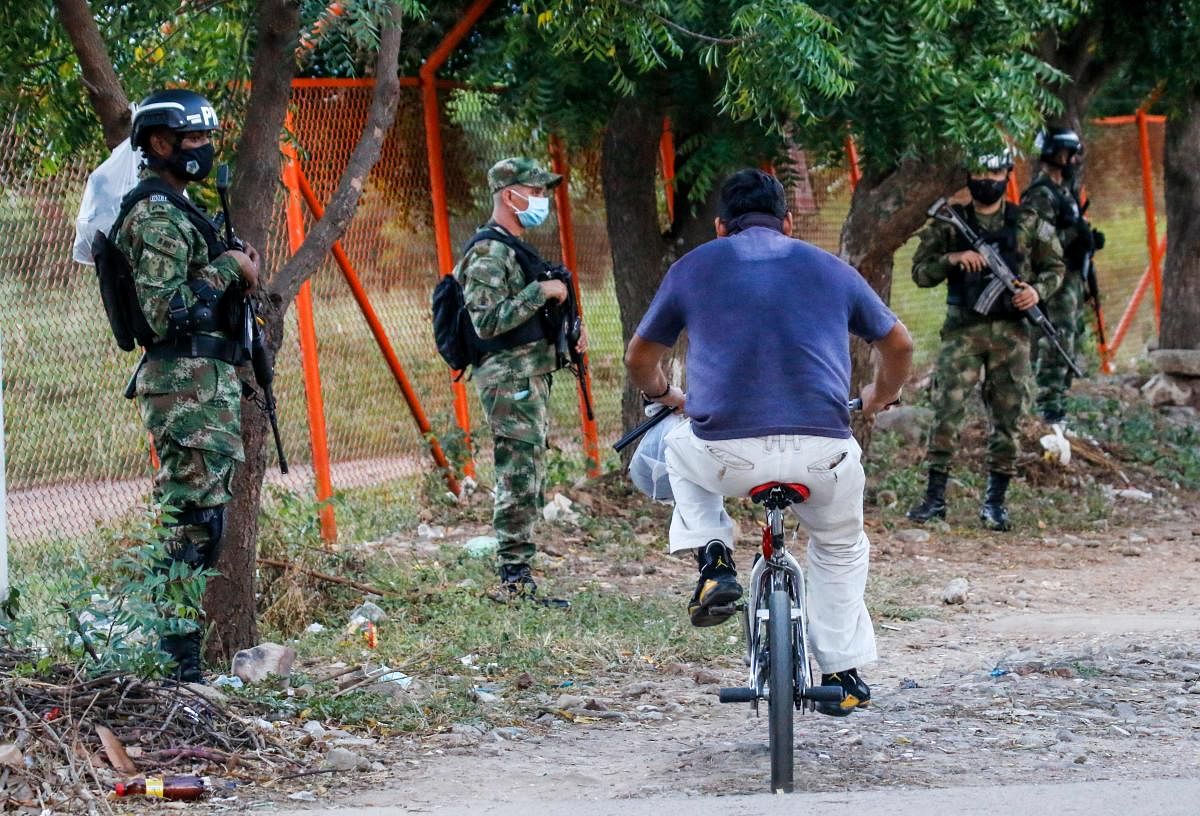 Soldiers stand guard outside the Camilo Daza International Airport after the presidential helicopter was hit by gunfire in Cucuta, Colombia. Credit: AFP Photo