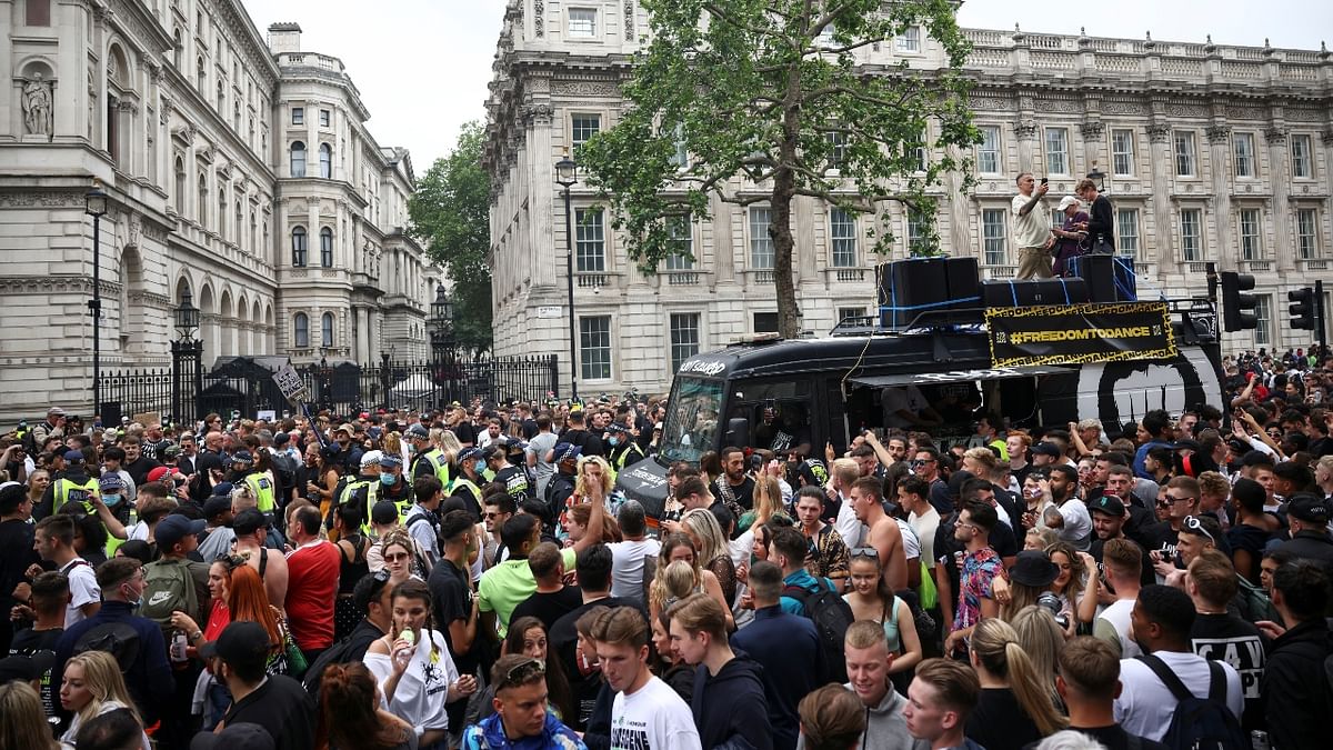 The throng marched from Hyde Park, through Oxford Street and towards parliament, carrying flags, whistling and shouting as they demanded an immediate end to restrictions.
