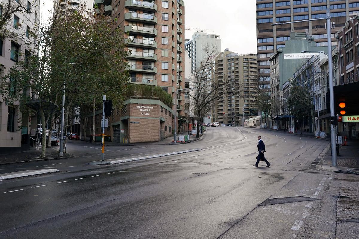 A pedestrian crosses an empty intersection at morning commute hour in the city centre during a lockdown to curb the spread of a coronavirus outbreak in Sydney, Australia. Credit: Reuters Photo