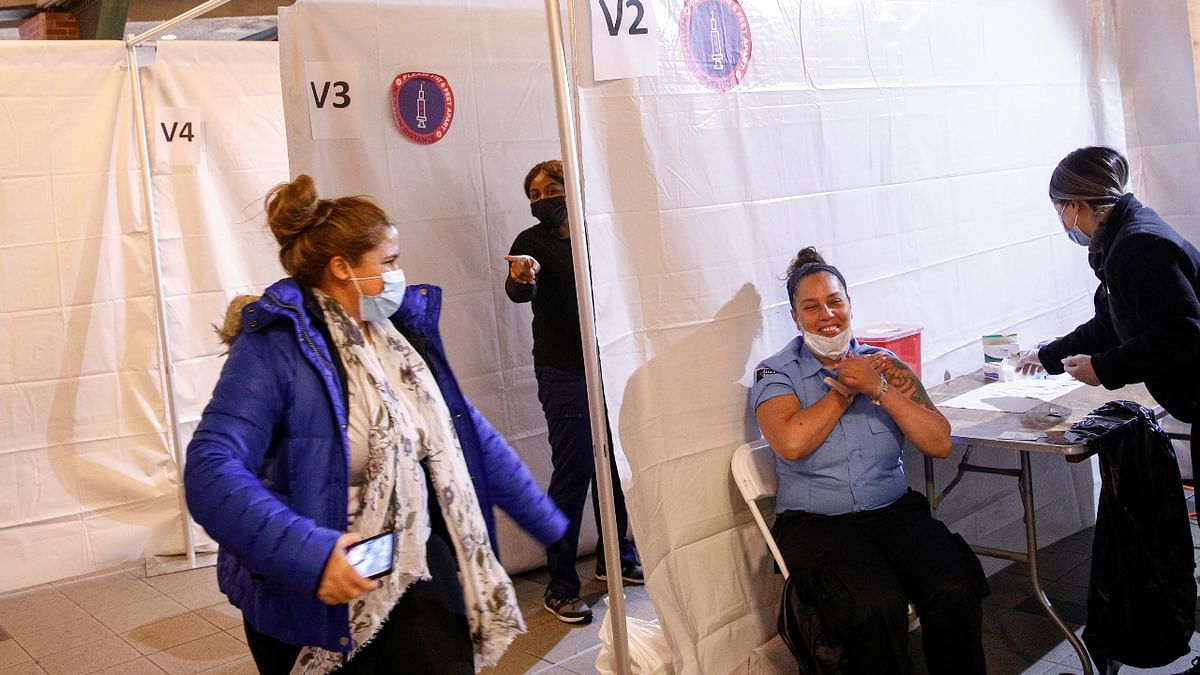 MTA security contractor Janet Santiago reacts after she received a shot of the Johnson & Johnson vaccine for Covid-19 during the opening of MTA's public vaccination program at the Coney Island subway station in the Brooklyn borough of New York City, New York. Credit: Reuters Photo