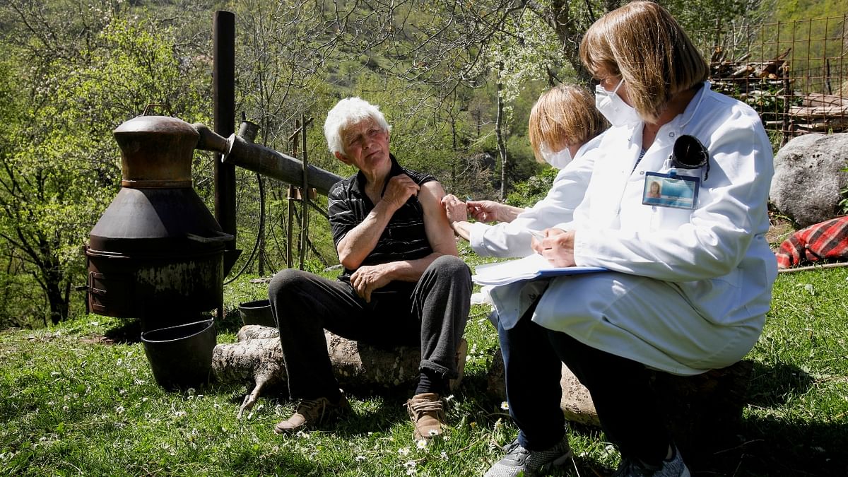A man receives Covid-19 vaccine next to a brandy pot still in the remote mountain village Ljevista, Kolasin municipality, Montenegro. Credit: Reuters Photo