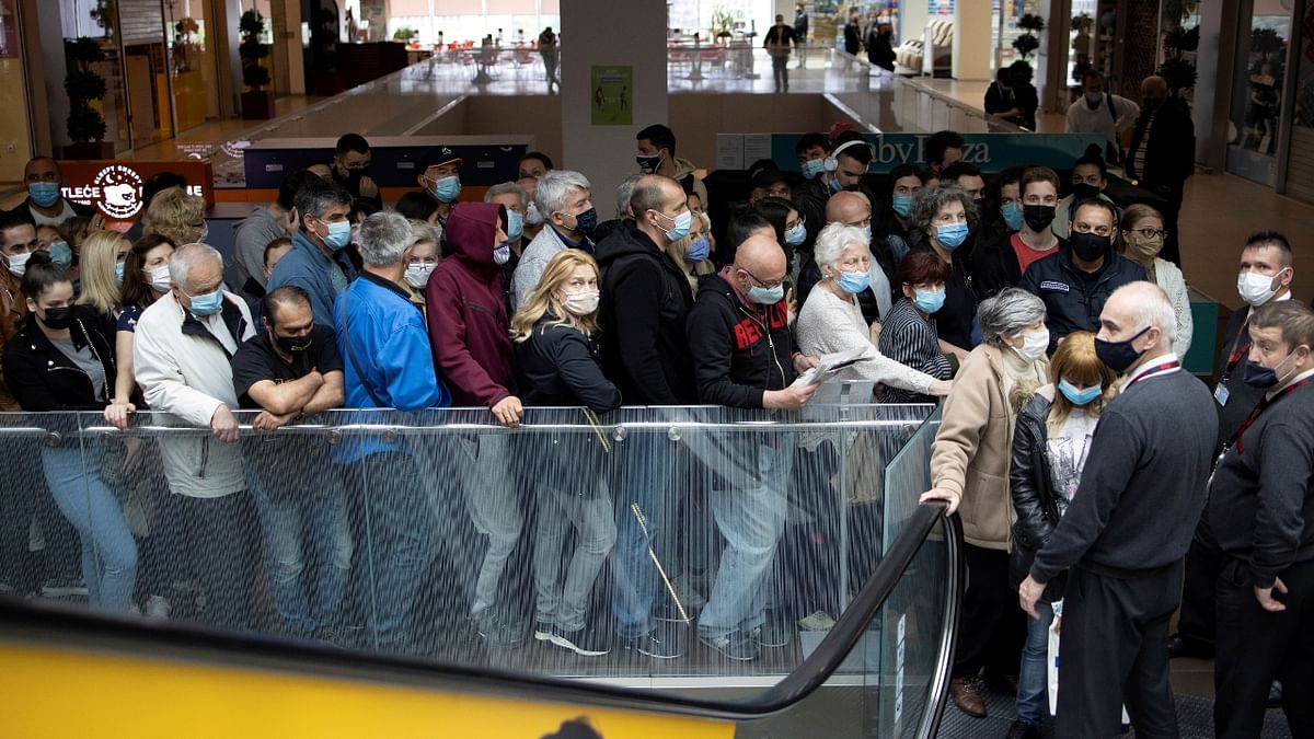 People wait to get shots of vaccines against Covid-19 in the USCE shopping mall, where the first 100 vaccinated will receive a discount voucher worth 3,000 dinars ($30.74) secured by mall's management and retailers, in Belgrade, Serbia. Credit: Reuters Photo