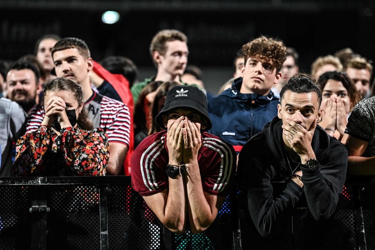 France's supporters react during the broadcast of the UEFA EURO 2020 round of 16 football match between France and Switzerland in a fan zone set up at the Gerland stadium in Gerland near Lyon. Credit: AFP Photo