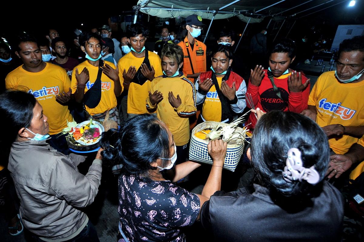 Passengers who survived the sunken ferry KMP Yunice, pray and perform a ritual as they arrive at Gilimanuk port in Bali, Indonesia. Credit: Reuters Photo
