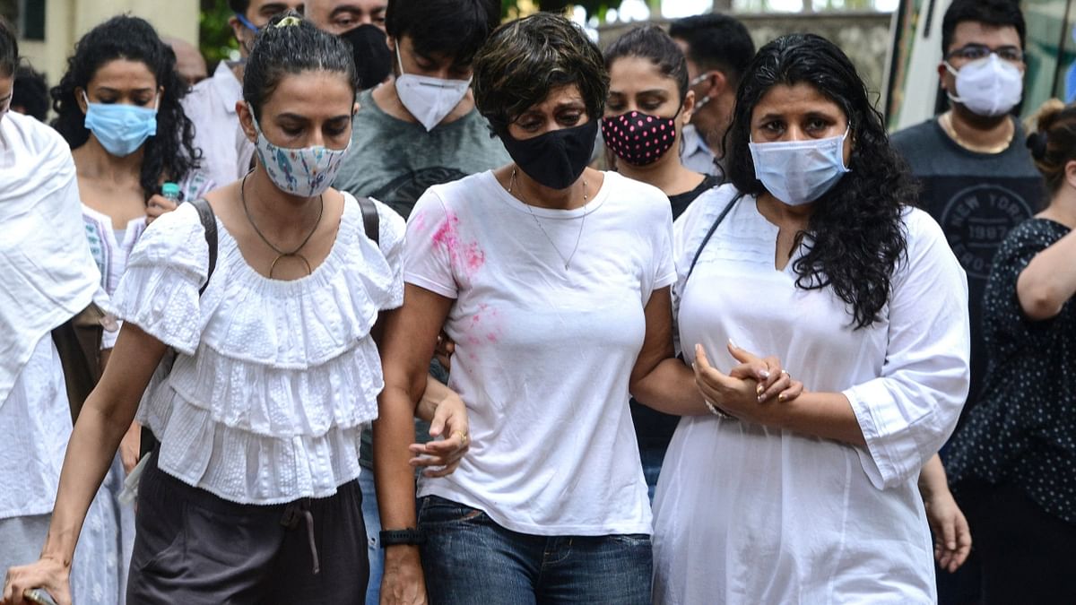 Filmmaker Raj Kaushal, who died early morning on Wednesday following a heart attack, was laid to rest in Mumbai. The funeral procession saw the presence of who’s who from Bollywood. In this photo, Mandira Bedi is flanked by her friends during Raj Kaushal's funeral. Credit: AFP