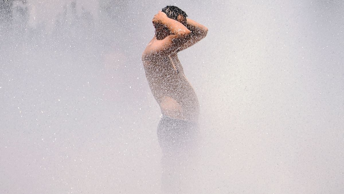 A man cools off in the Salmon Street springs fountain in Portland, Oregon.
