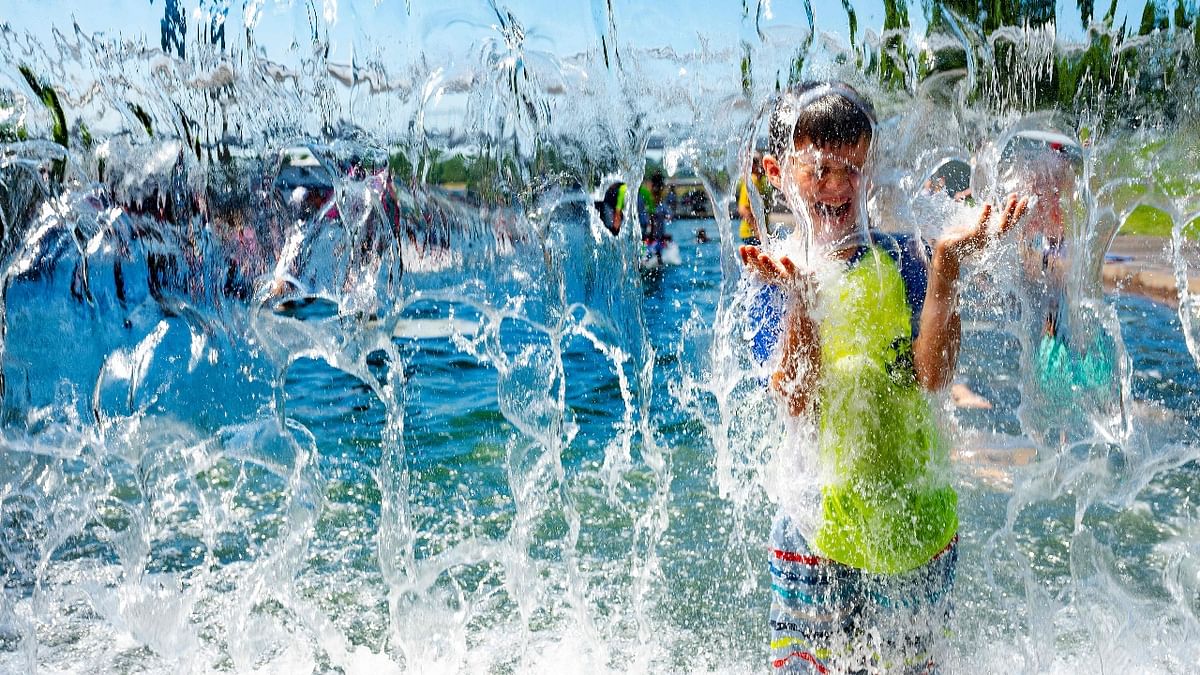 A young boy enjoys in water park to get relief from the scorching heat in Washington, DC.