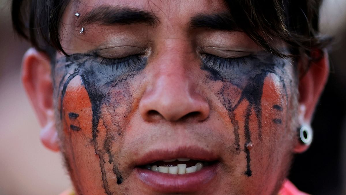 Michael Mbya, an indigenous man of the Guarani tribe, takes part in a protest against a proposed bill allowing commercial agriculture and mining on protected tribal reservations, curtailing indigenous land rights, in Brasilia, Brazil. Credit: Reuters Photo