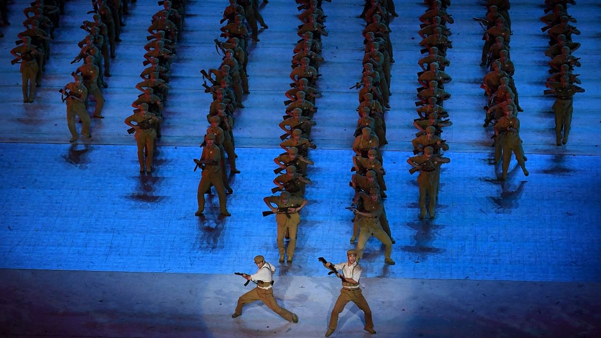 Cultural performers dance on the stage during the celebration of the 100th Anniversary of the Founding of the Communist Party of China, at the Bird's nest national stadium in Beijing. Credit: AFP Photo