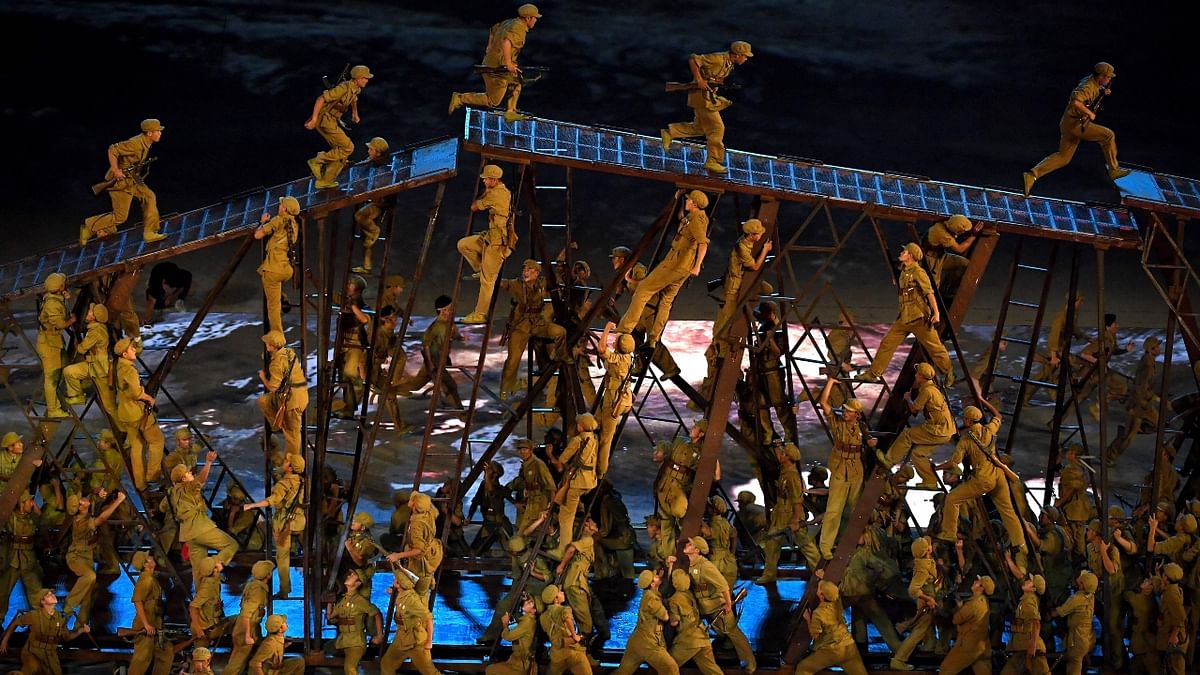 Performers dressed in Army dress perform during a Cultural Performance as part of the celebration of the 100th Anniversary of the Founding of the Communist Party of China, in Beijing. Credit: AFP Photo