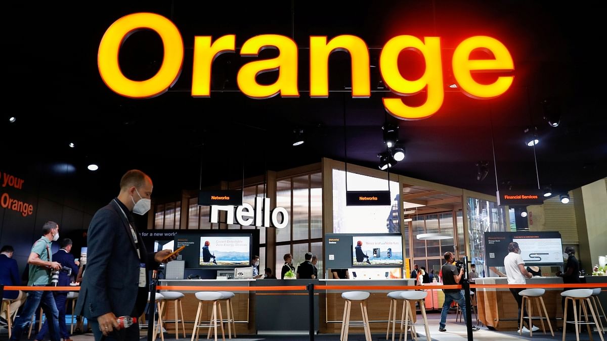 A man walks past a stand of telecom operator Orange, at the Mobile World Congress (MWC) in Barcelona, Spain. Credit: Reuters Photo