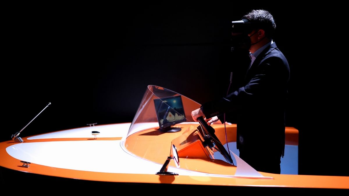 A tech expert Daniel Delgado uses a 3D VR Glasses on a model of ship, during the Mobile World Congress (MWC) in Barcelona, Spain. Credit: Reuters Photo