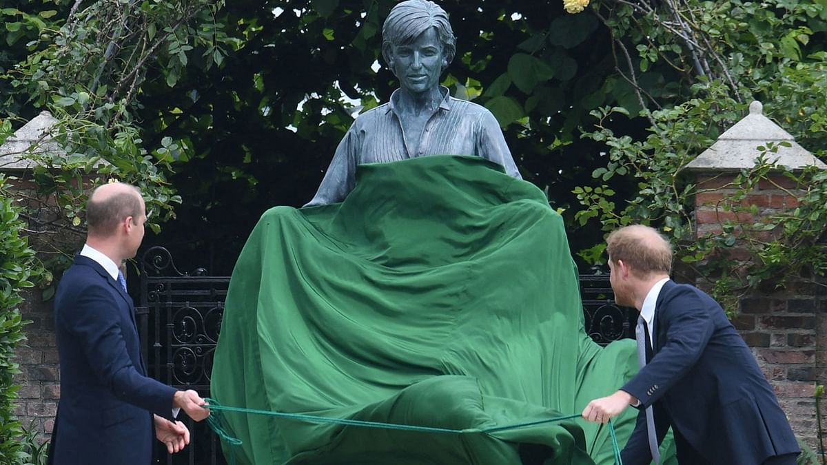 Gently pulling two green cords, they unveiled a bronze statue that depicted Diana with children gathered in her outstretched arms.