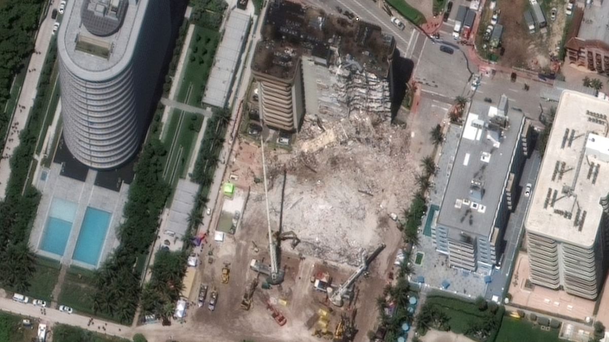 A satellite view shows the collapsed Champlain Towers condo building, in Surfside near Miami Beach, Florida, US. Credit: @Maxar Technologies/Handout via Reuters