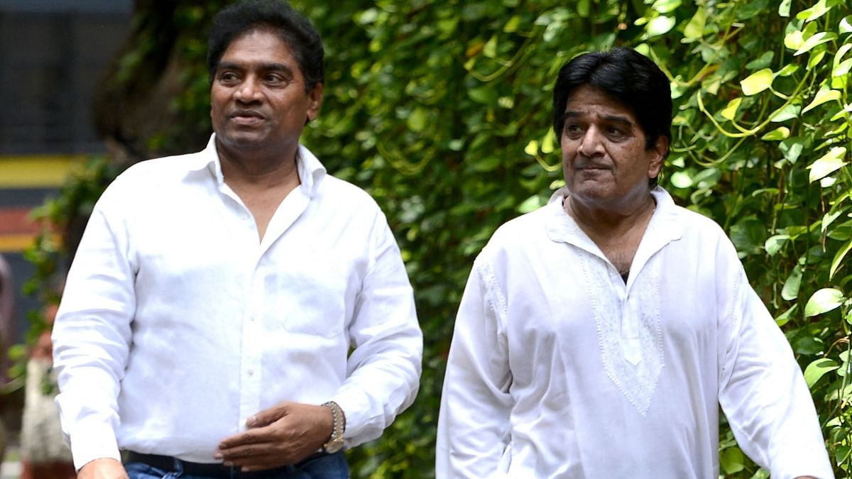 Comedian Johnny Lever arrives with a friend. Credit: AFP Photo