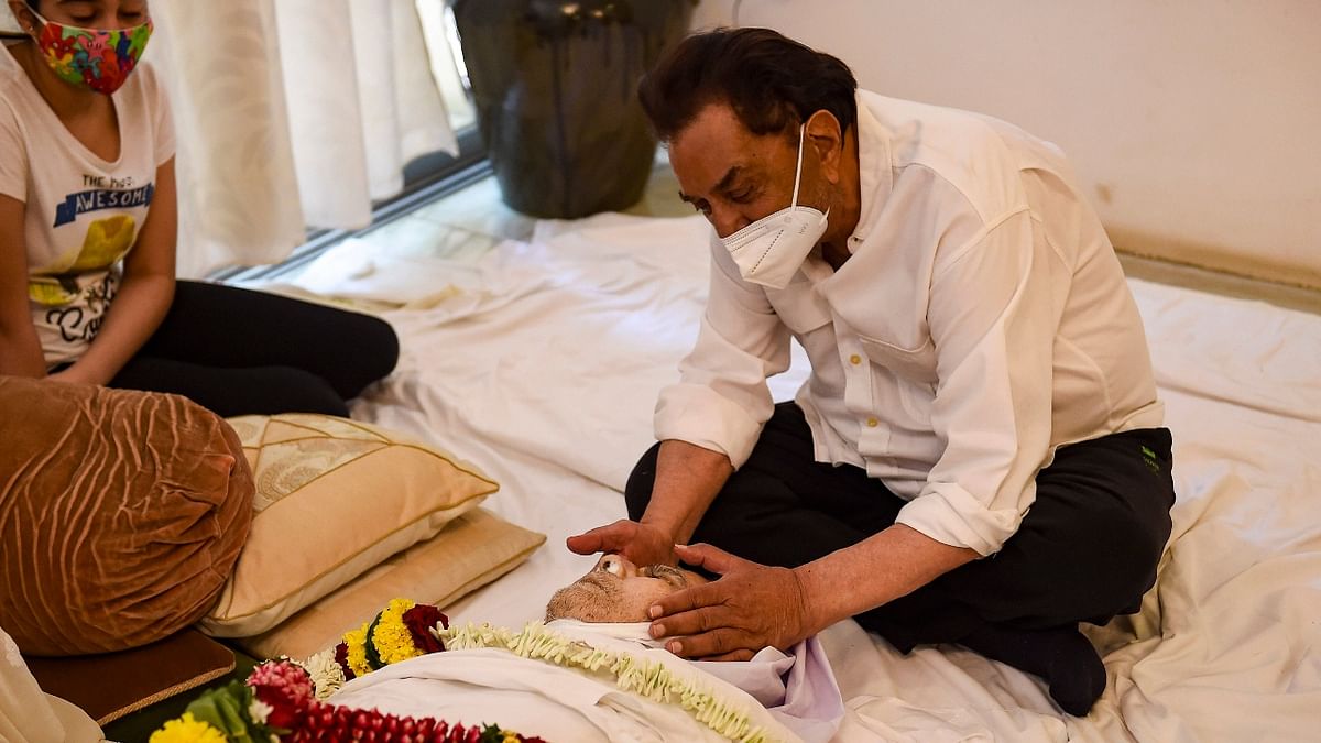 An emotional Dharmendra paying his last respects. Credit: PTI Photo