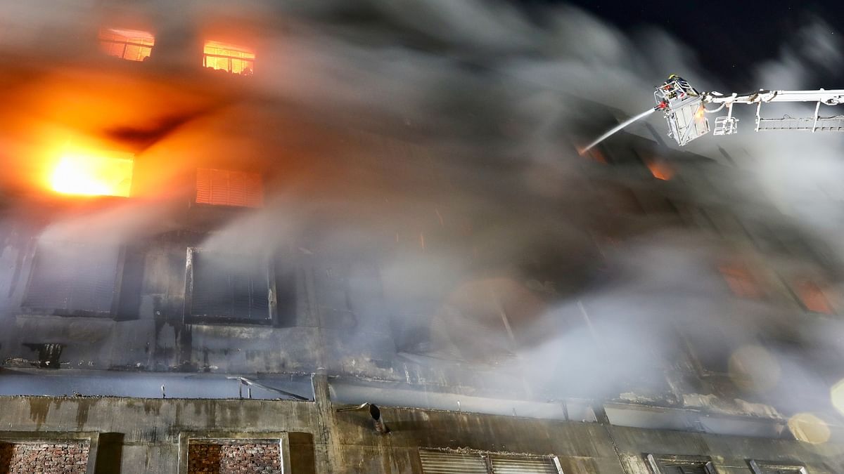 Firefighters try to douse a fire that broke out a day before in a beverage and food factory in Rupganj, Bangladesh. Credit: Reuters Photo