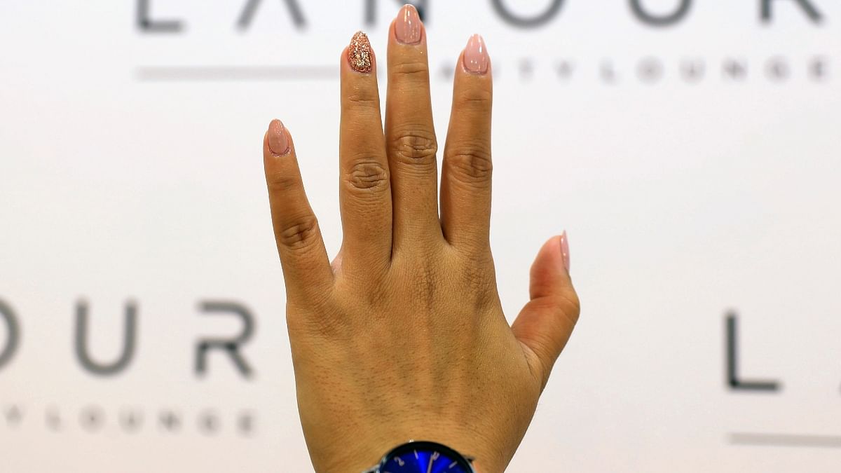 A customer flaunts her nails after getting the microchip manicure at Lanour Beauty Lounge in Dubai, United Arab Emirates.